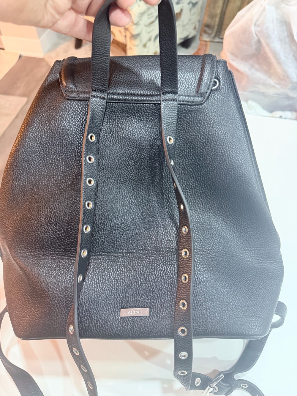 ALDO black faux leather backpack featuring a pebbled texture